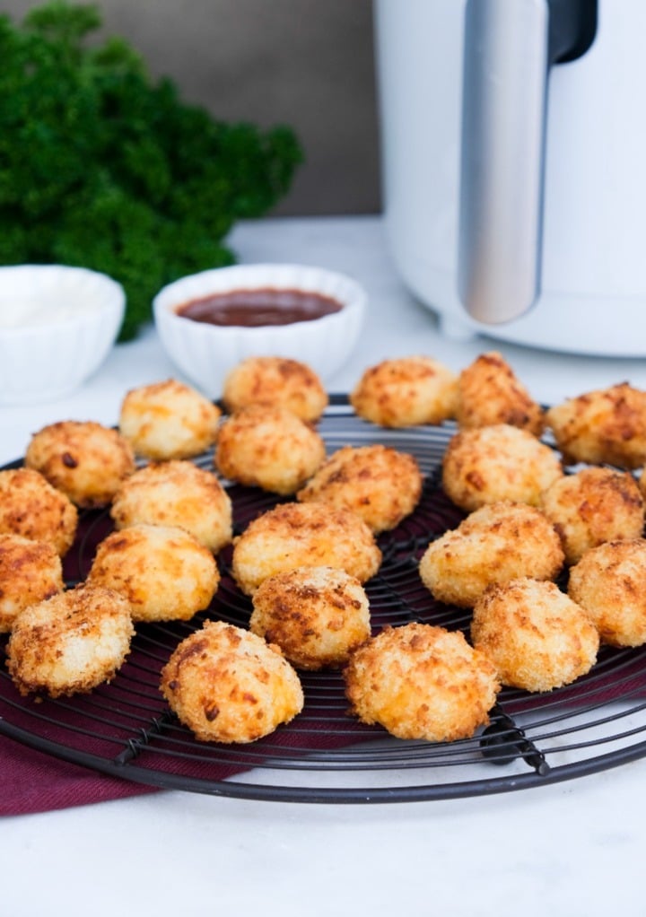 Potato bites on a cooling rack after cooked in an air fryer.