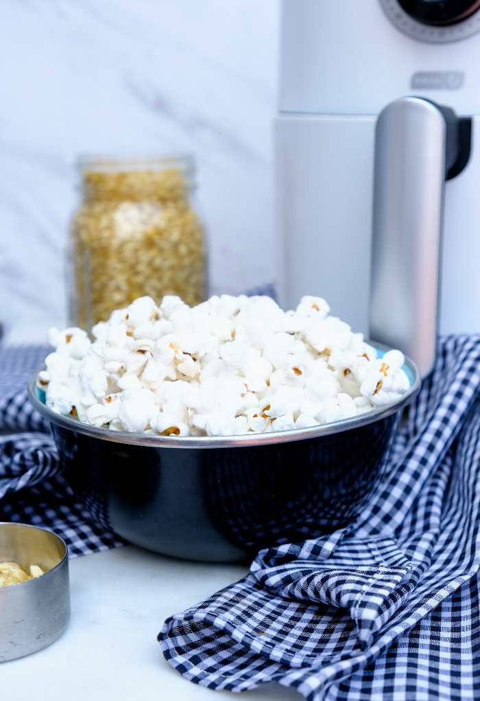 Air fryer popcorn in a black serving bowl.