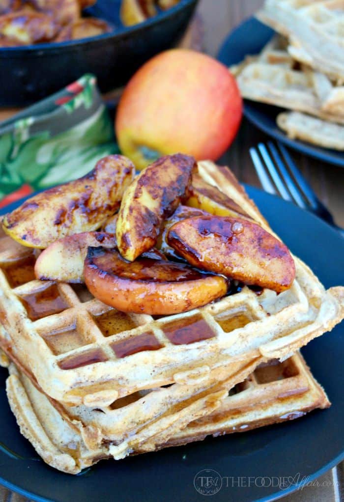 Plate of whole wheat waffles topped with cooked apples.