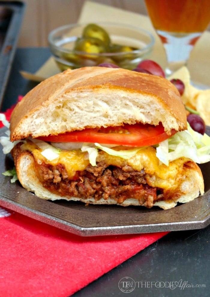 This Bacon Cheeseburger Stuffed French bread is packed with a flavorful beef mixture and then topped with a gooey layer of cheese! Add additional condiments for a full burger experience! The Foodie Affair