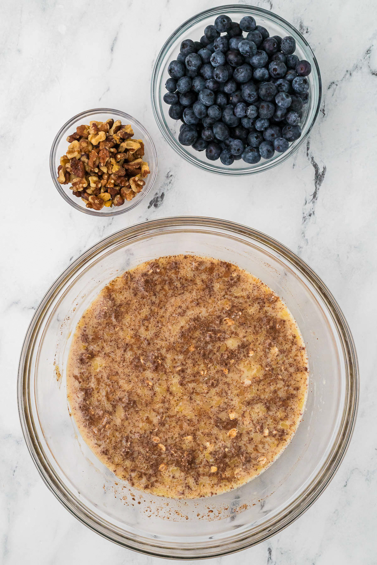 Oatmeal bake ingredients in a mixing bowl before placing in a baking dish.
