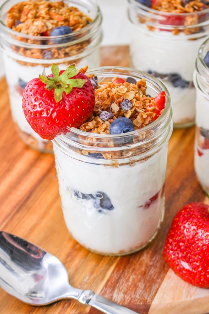 Homemade breakfast parfait with yogurt, and fresh fruit in a mason jar.