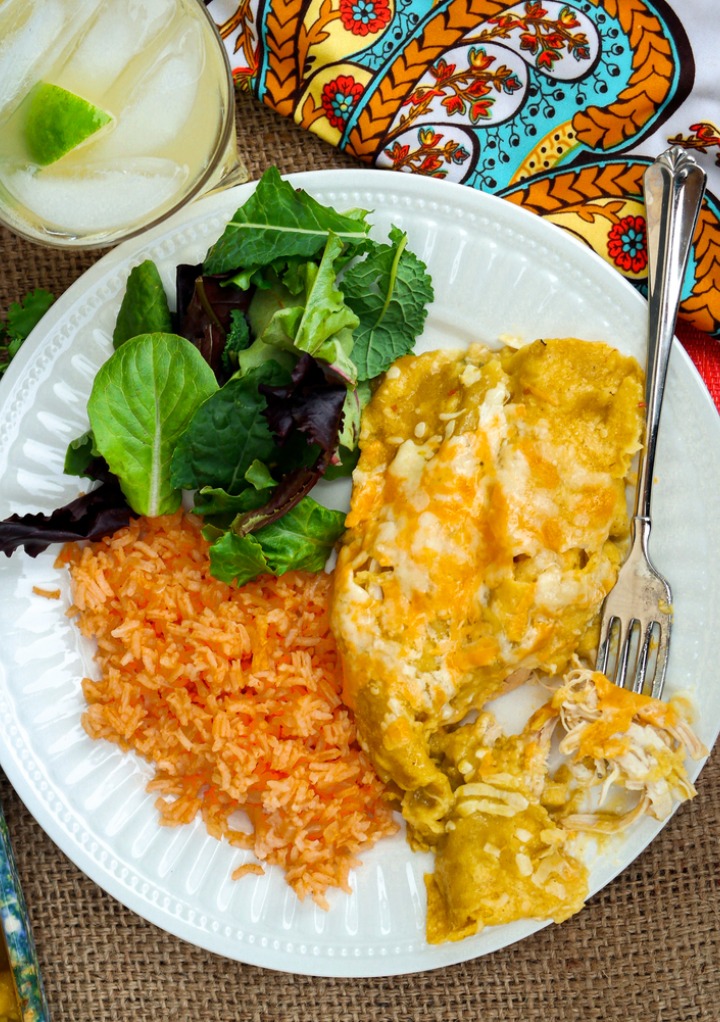 Top view of chicken enchiladas with Spanish rice and salad.