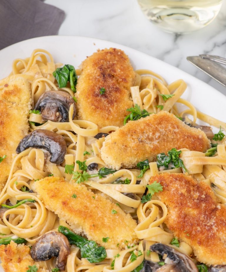 Copycat Olive Garden chicken marsala recipe on a platter with fettuccini.
