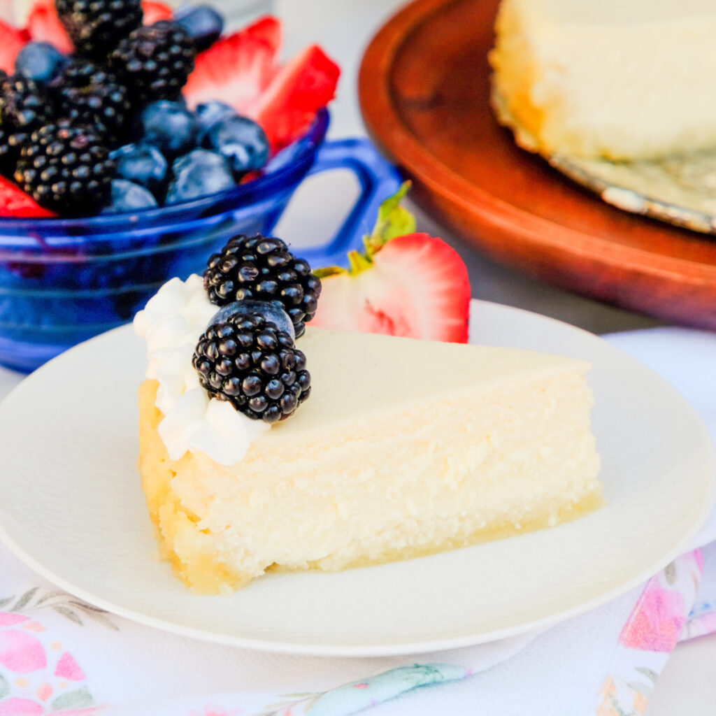 A slice of keto cheesecake made with cottage cheese on a white serving plate.