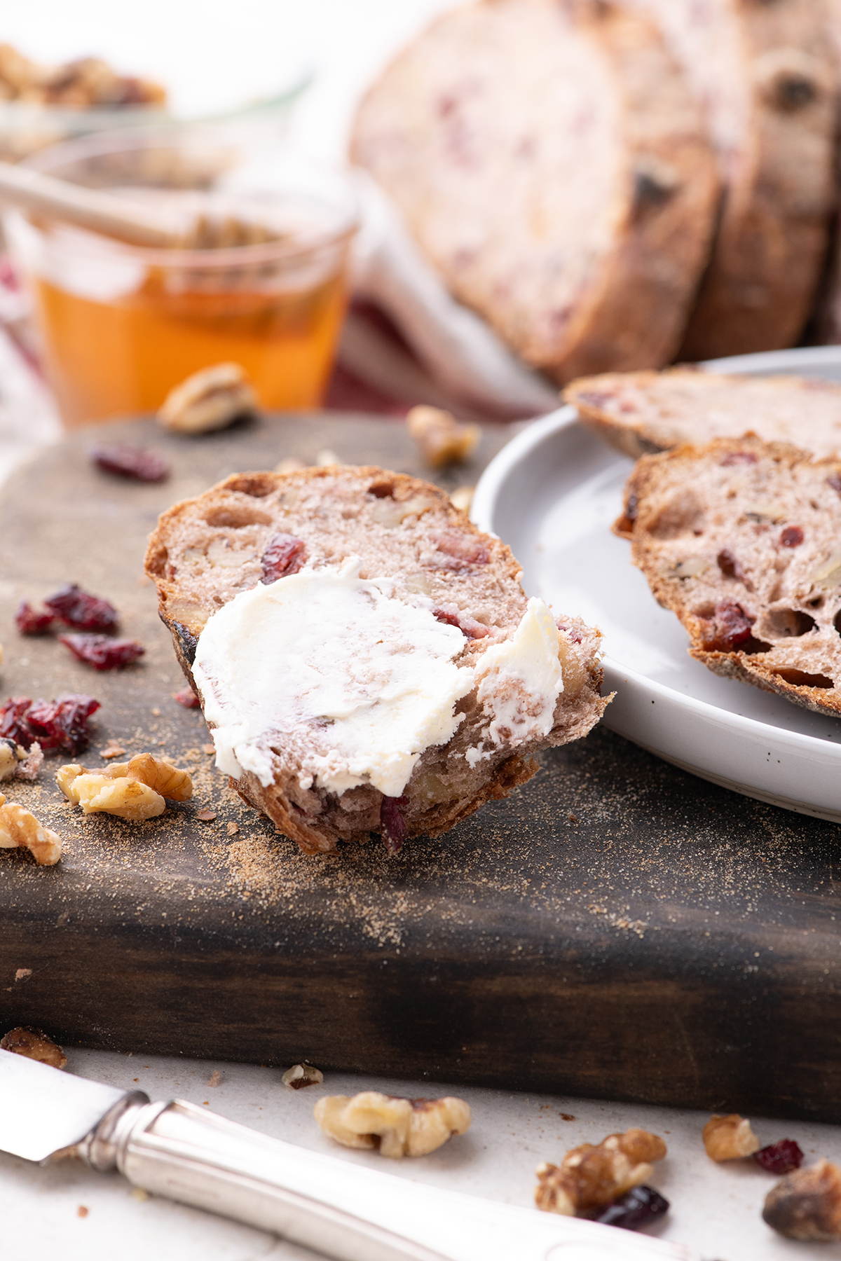 A slice of bread on a dark wood cutting board.