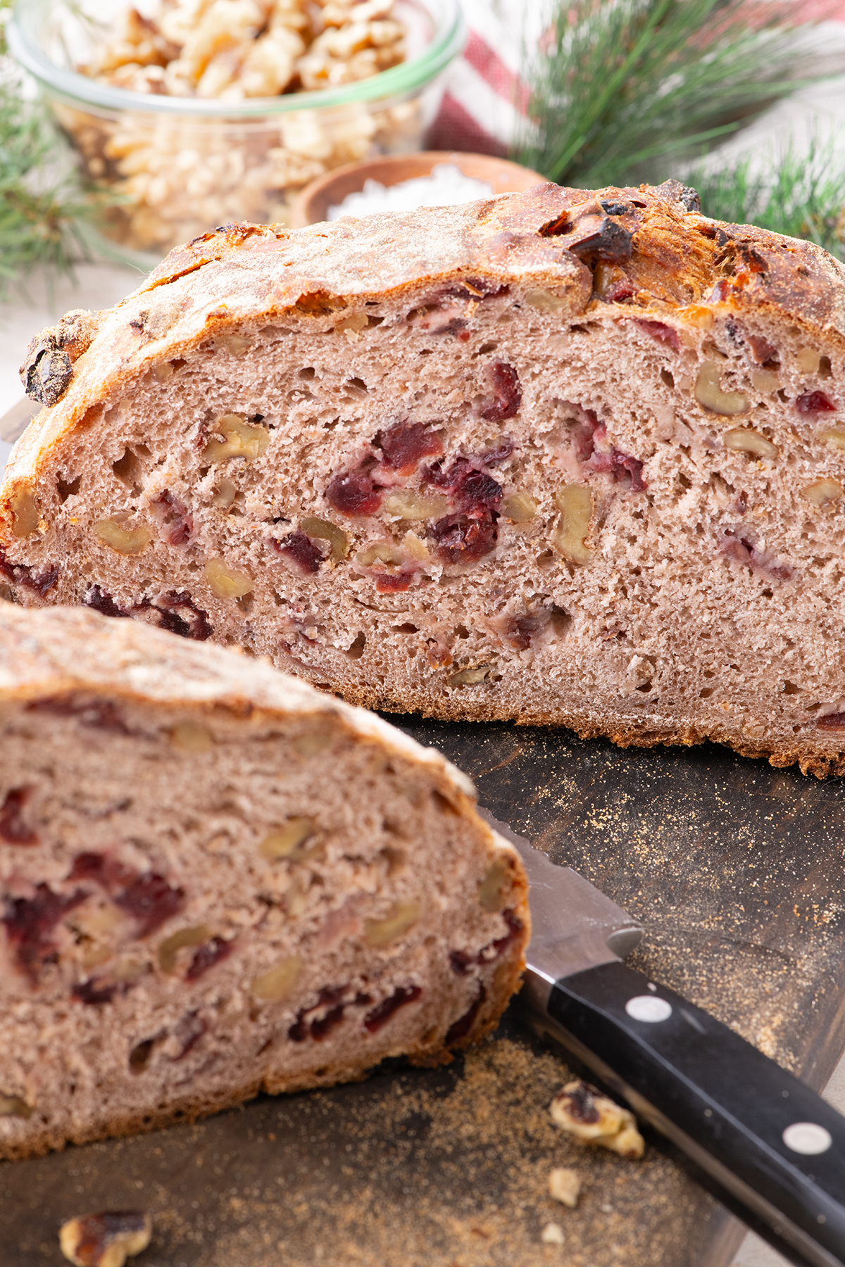 Sliced round loaf of bread with cranberries.