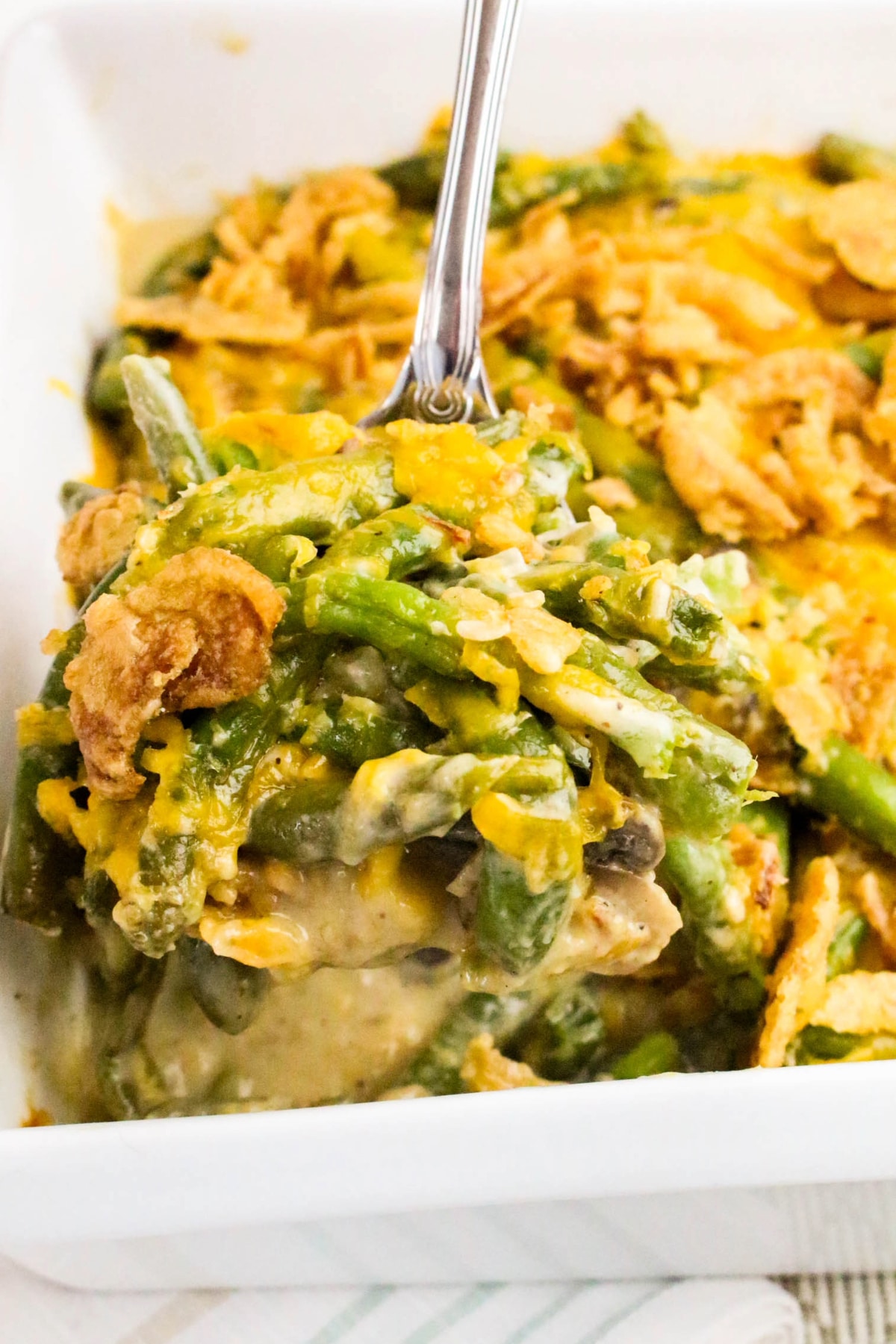 Classic green bean casserole with cheese and fried onions.