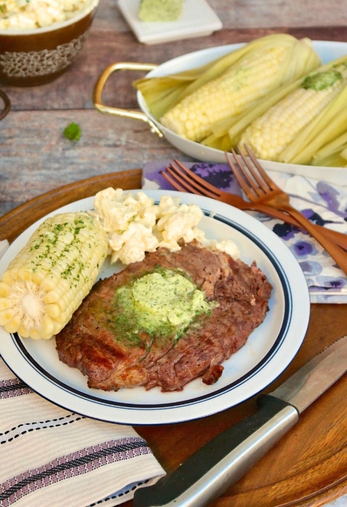 Grilled Rib Eye Steak with Corn on a white plate