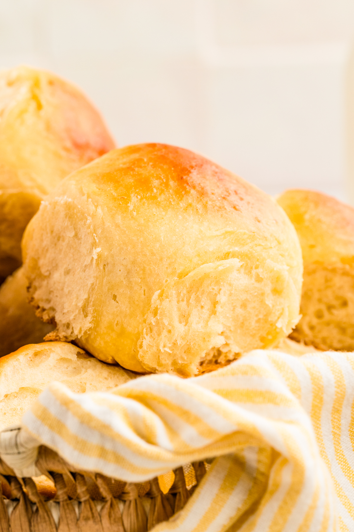 Close view of a homemade Hawaiian dinner roll in a basket.