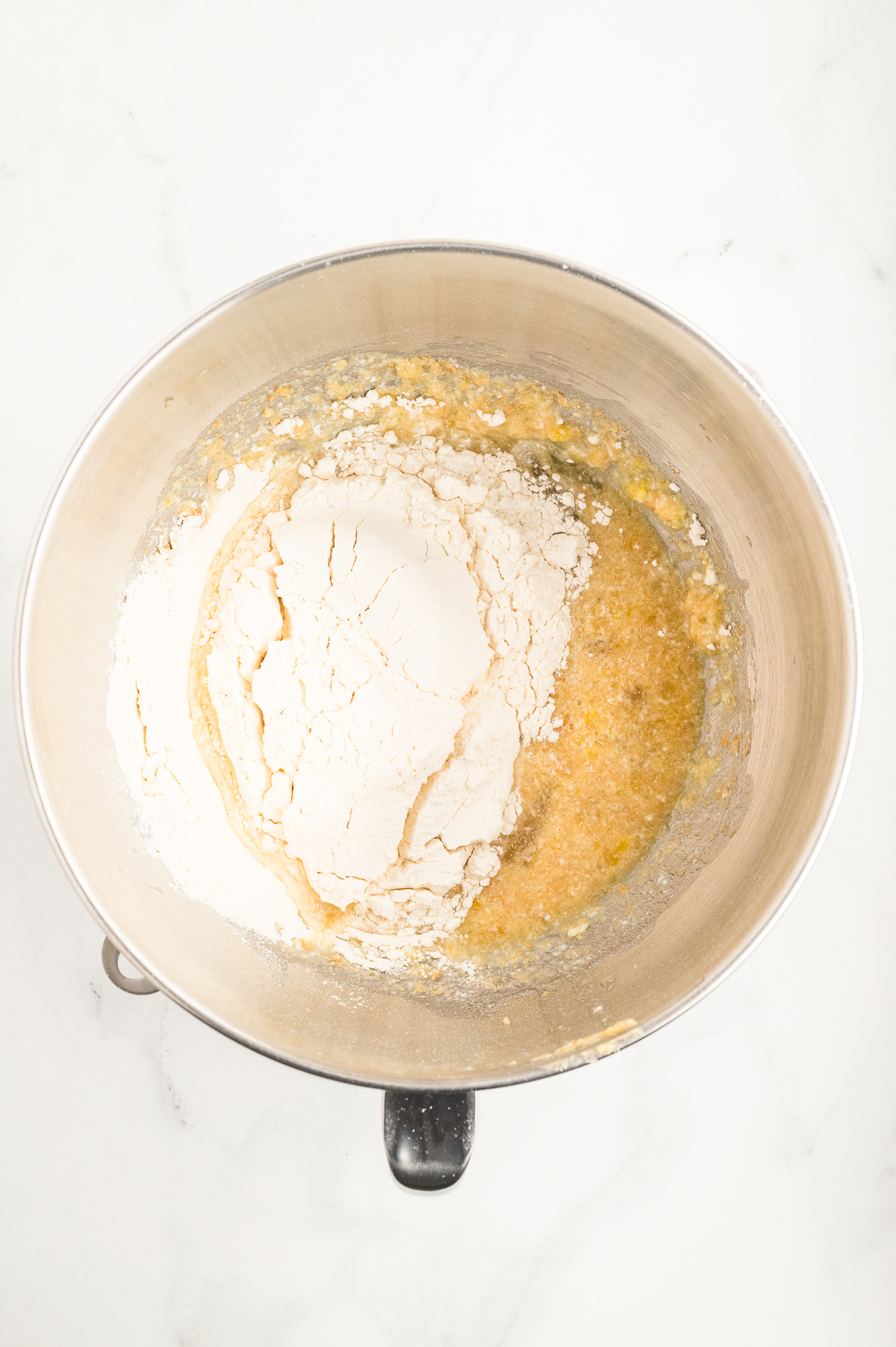 Flour added to ingredients to make dinner rolls.