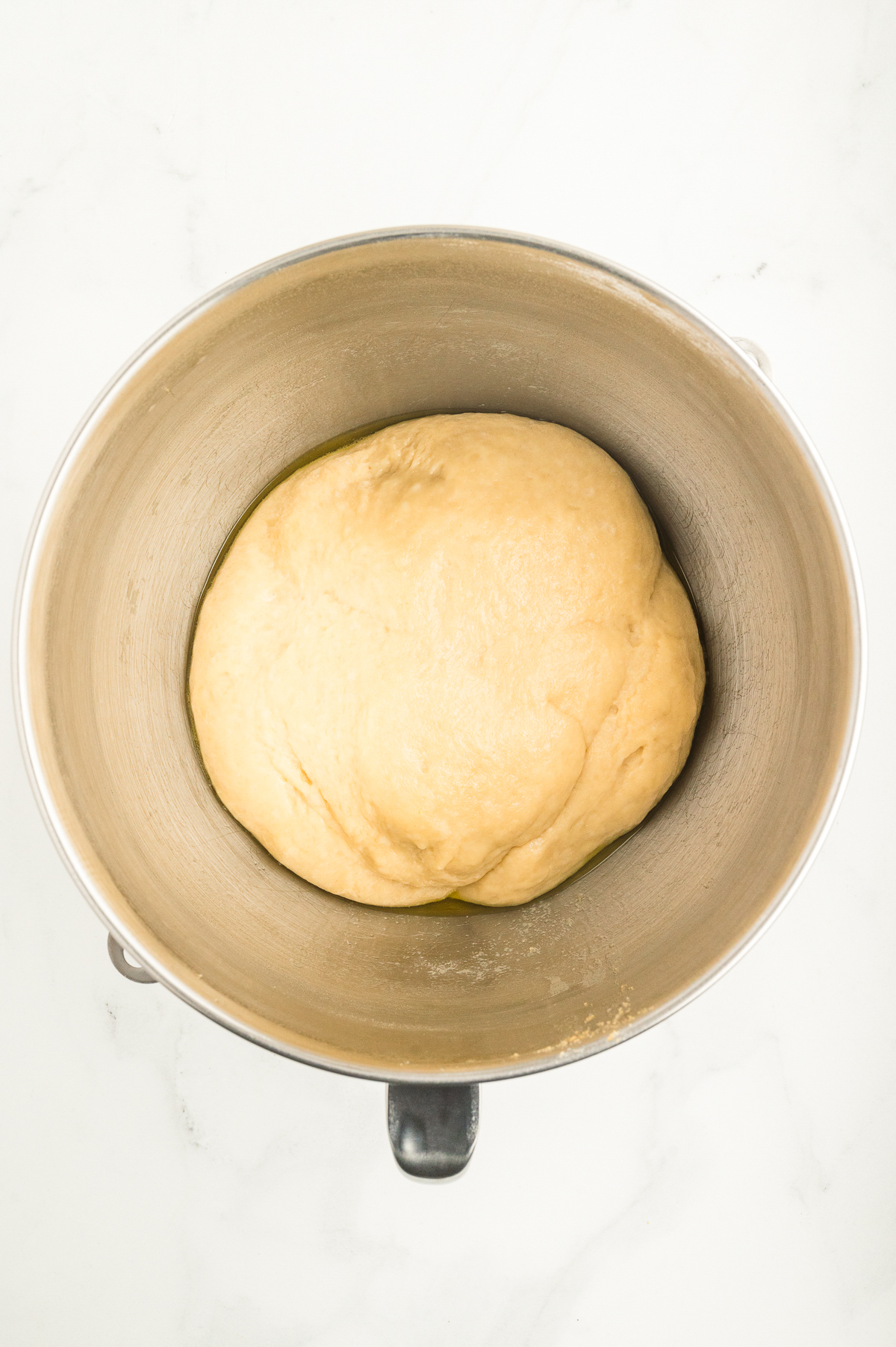First rise proofed dinner rolls dough before forming and baking.
