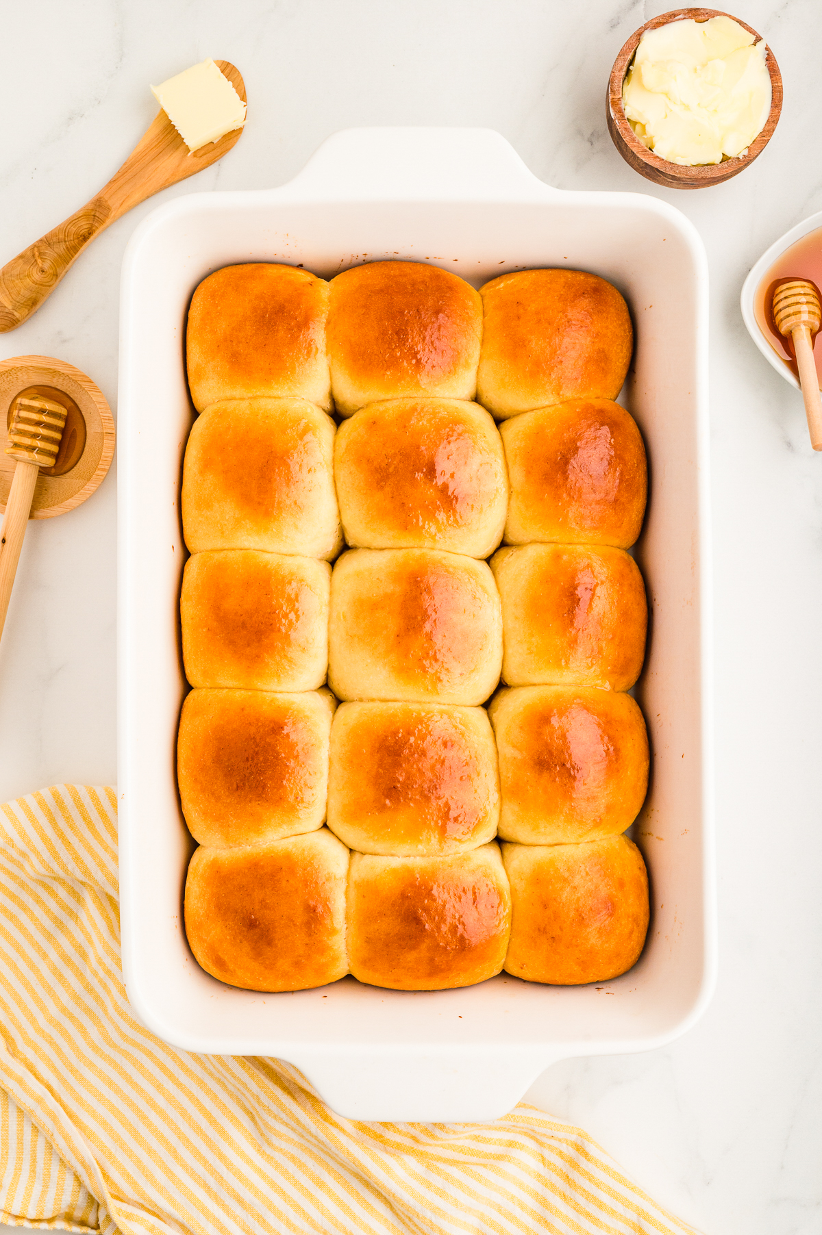 Baked Hawaiian rolls in a white baking dish.
