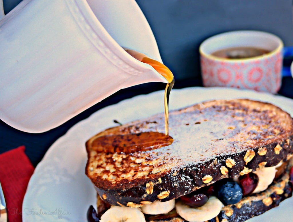High Protein French Toast Sandwich with maple syrup on a white plate.