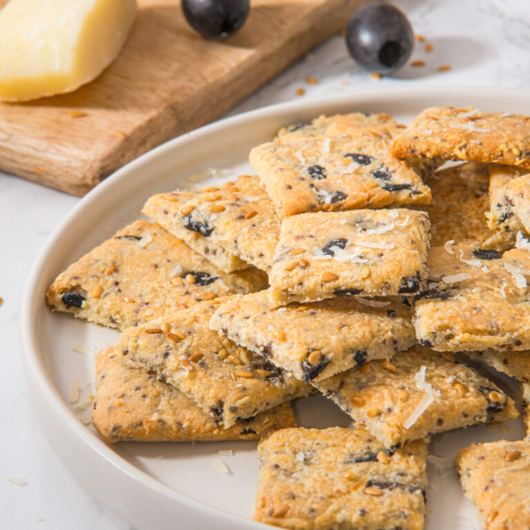 Homemade low carb crackers on a white serving dish.