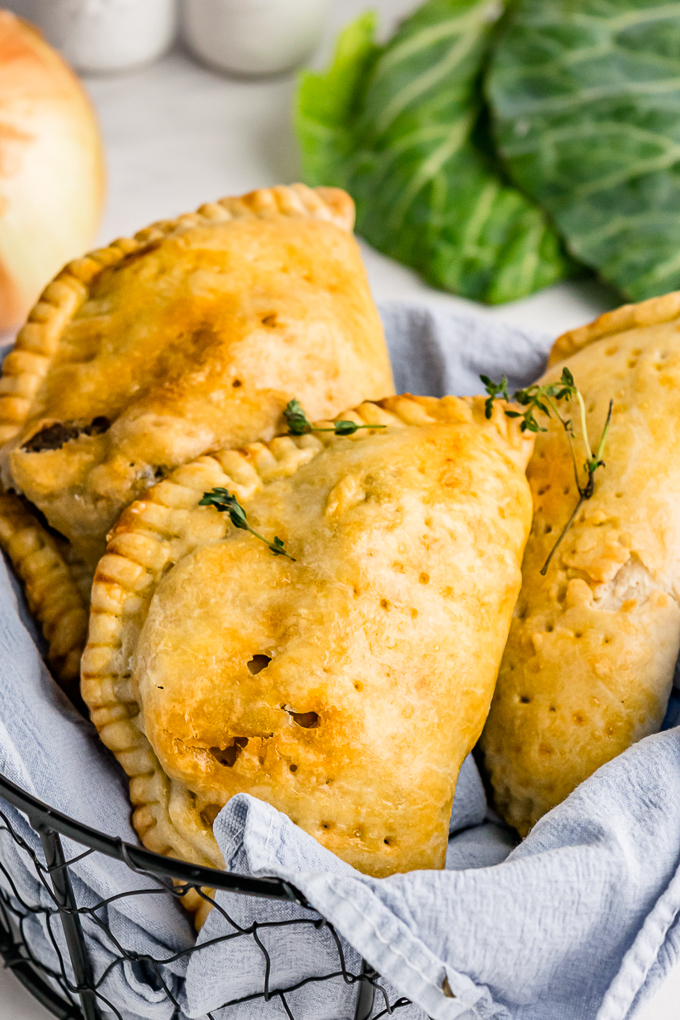 Meat hand pies in a basket ready to eat.