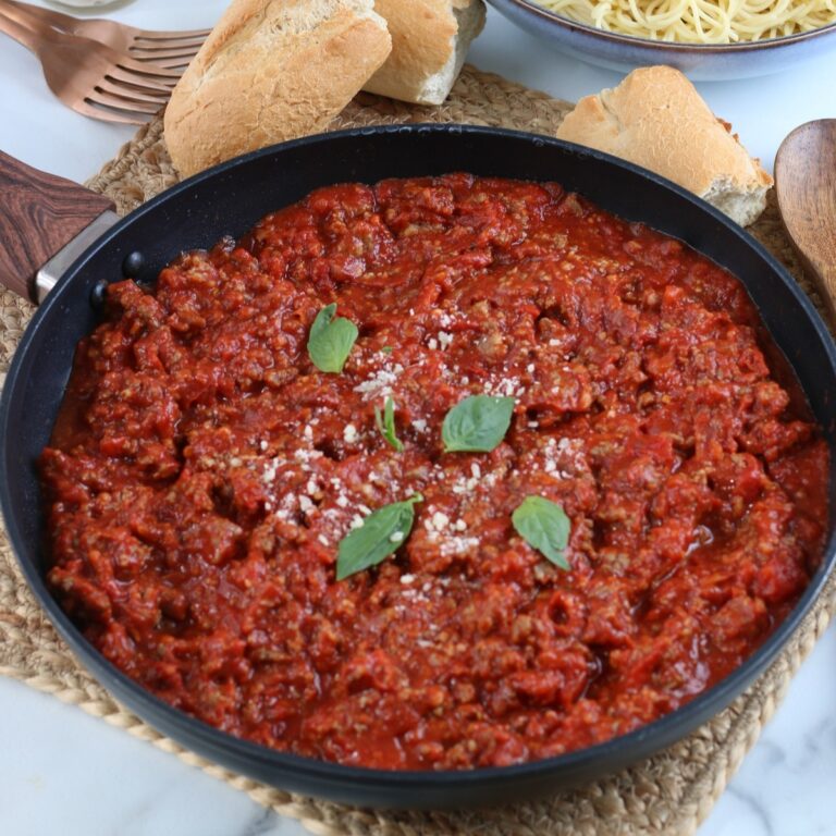 Homemade meat sauce in a skillet simmering
