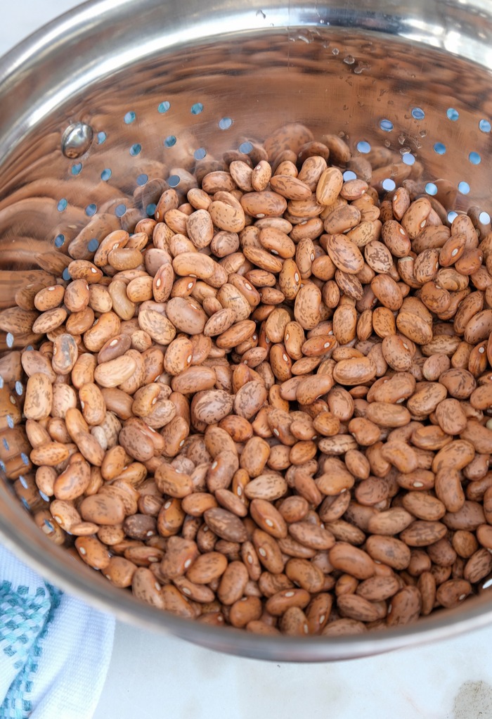 Rinsing beans in a colander.