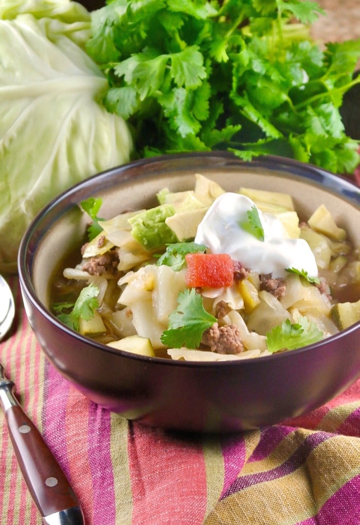 Low carb Mexican beef cabbage soup topped with avocado and crema for a delicious complete meal! #30minute #dinner #lowcarb #ketodiet #Mexican | www.thefoodieaffair.com