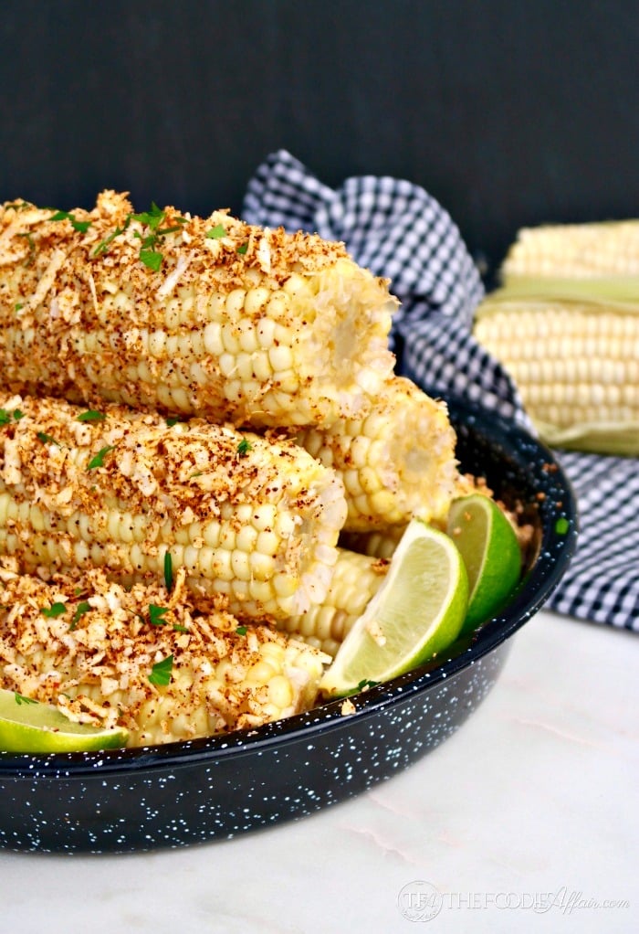 Easy Mexican Style Corn on the Cob topped with plenty of melted butter, chili powder, cotija cheese, salt and fresh lime juice.