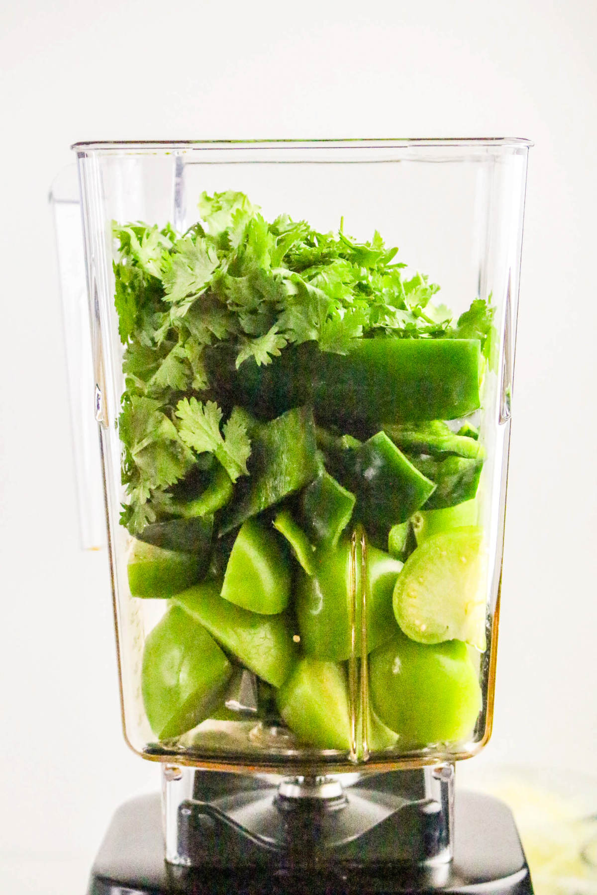 Ingredients for tomatillo sauce in a blender.
