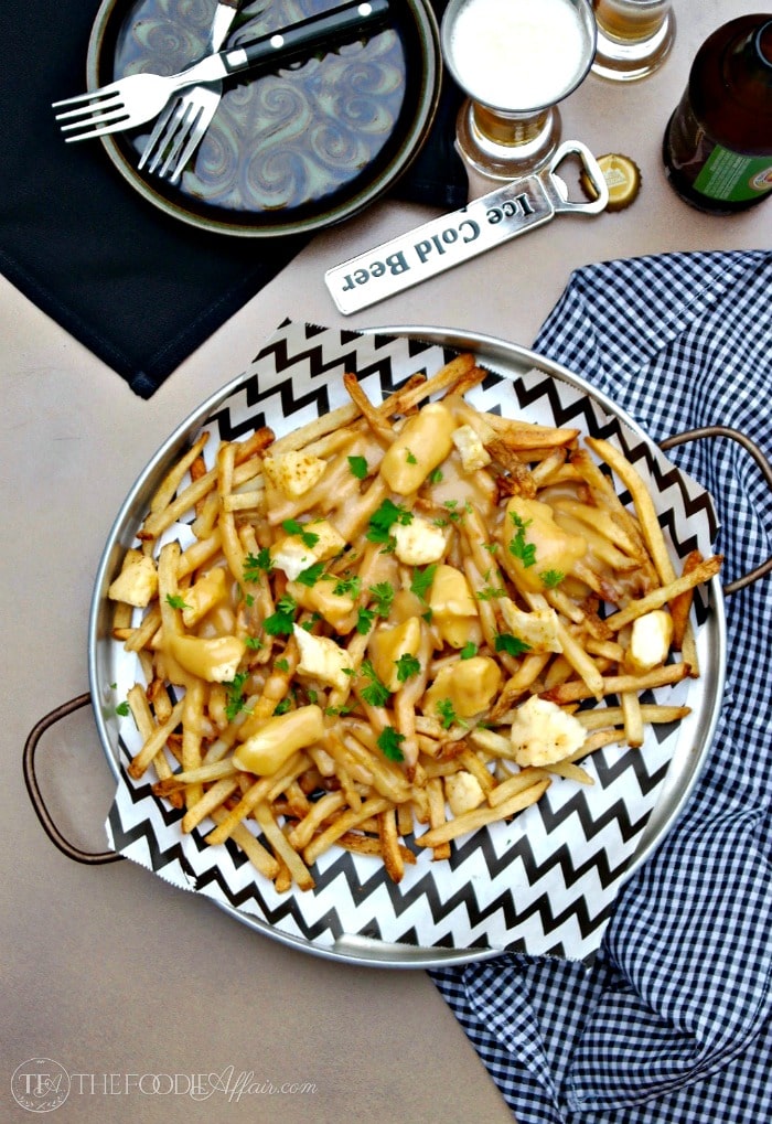 French-Canadian Poutine dish is made of French fries, cheese curds and light brown gravy! Flavorful and easy to make when you use pre-made fries!