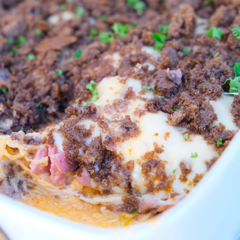 Reuben Casserole in a white dish scooped up ready to serve.