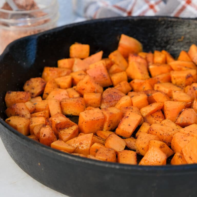 Diced sweet potatoes in a cast iron skillet.