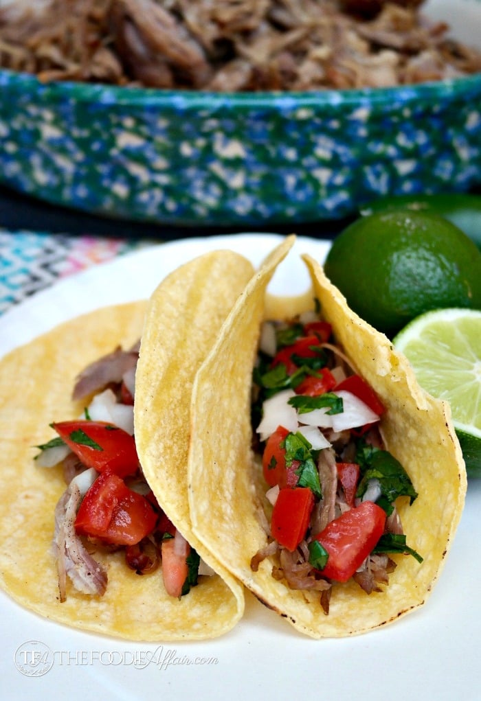 Carnitas wrapped in corn tortillas with pico de gallo