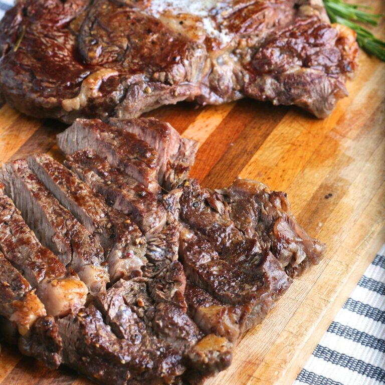 cooked steak on a cutting board