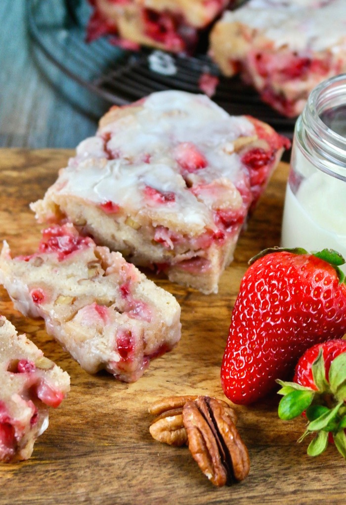 Glazed strawberry bread on a cutting board