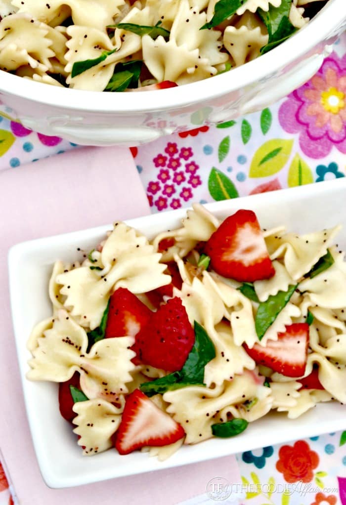 Strawberry Spinach Pasta Salad with a light poppy seed dressing. Great dish to add to cookouts and potlucks! The Foodie Affair