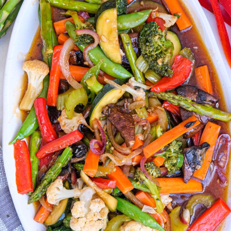 Top view of vegetable stir fry on a white serving plate.