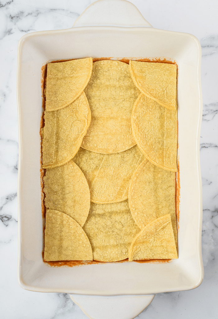 First layer of vegetarian enchiladas in a casserole dish.